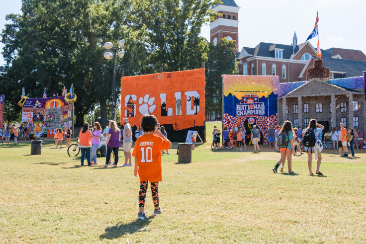 A child looks at floats on Bowman field during homecoming