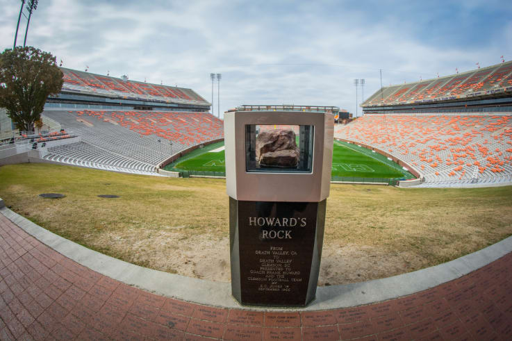 Howards Rock on its pedestal with memorial stadium in the background
