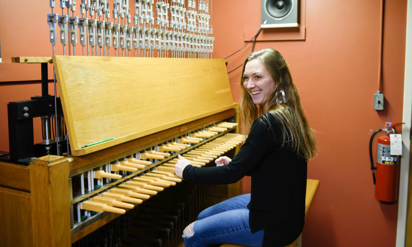 A student plays the Carillon Bells at the top of Old Main/Tillman Hall