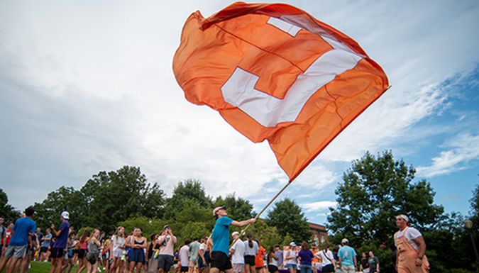 Clemson Students waving Clemson Flag at Welcome Rally, Clemson University