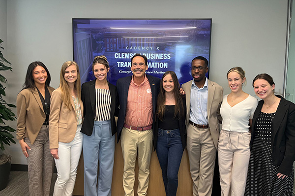 Cadency group undergraduate students standing with Tony Wagner