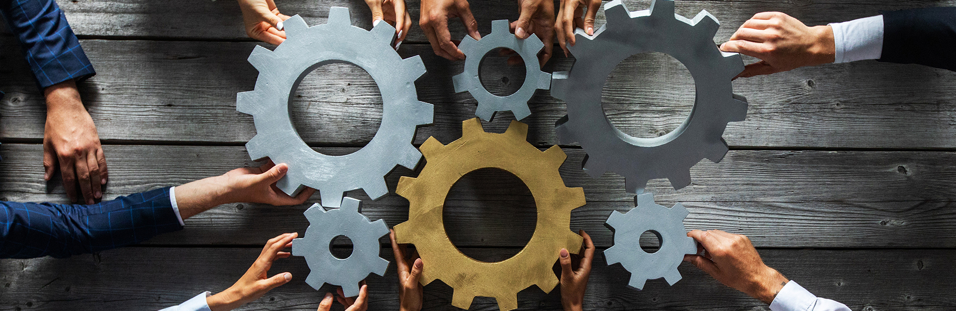 Hands holding to clogs as sign of collaboration